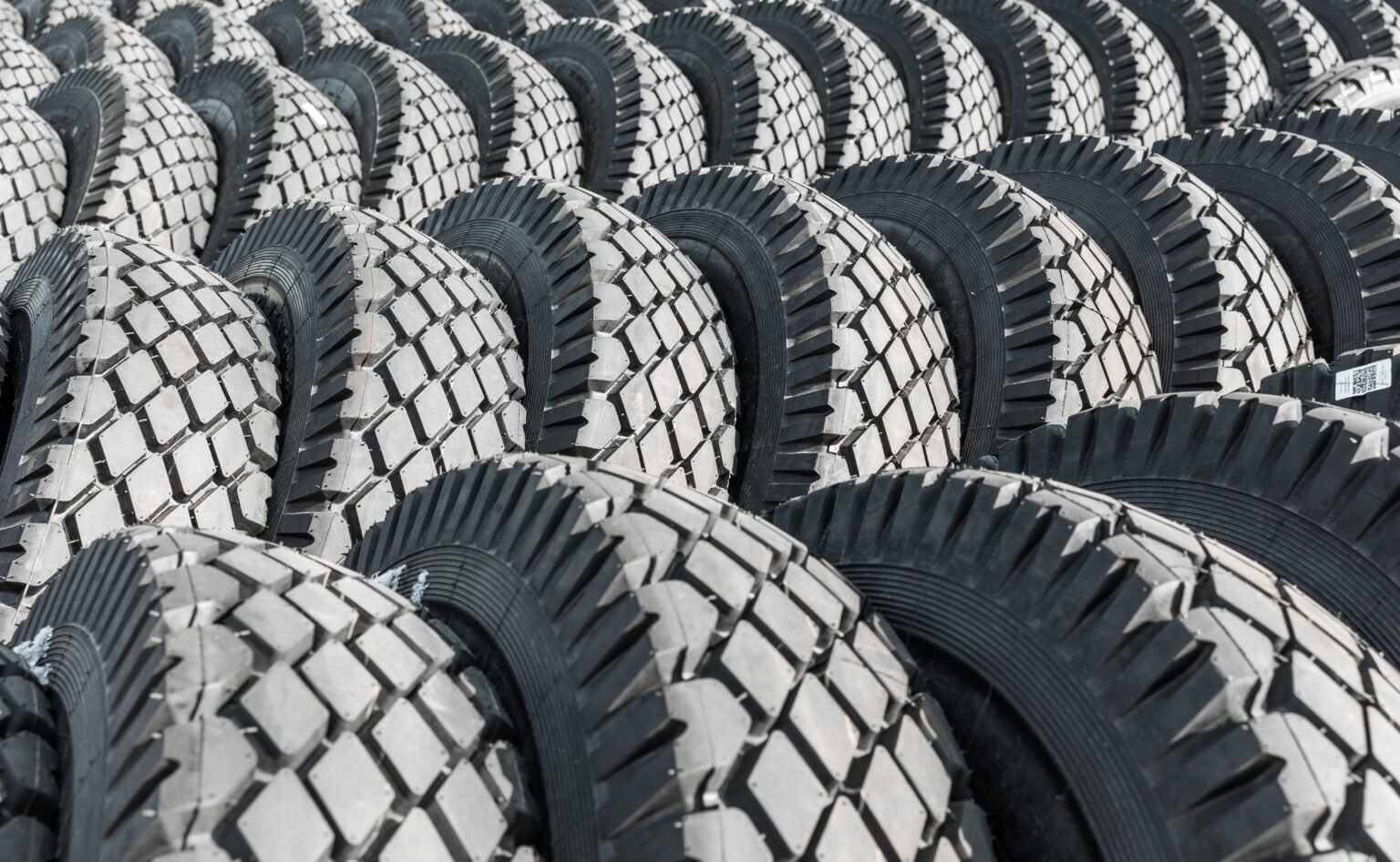 Photo of black big tires on wheels for large cars.