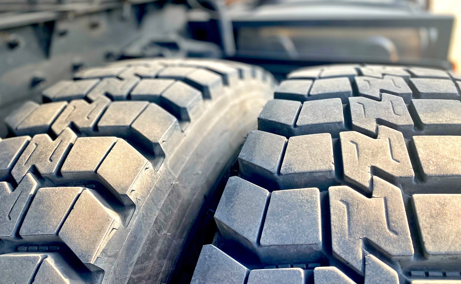 Photo of black big tires on wheels for large cars.